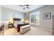 Serene bedroom with a large window, hardwood floors, and neutral decor at 20855 Omaha Ave, Parker, CO 80138