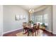 Well-lit dining room featuring hardwood floors, a chandelier, and a large window at 20855 Omaha Ave, Parker, CO 80138