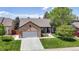 Charming single-story brick home with a well-manicured lawn and an attached two-car garage at 20855 Omaha Ave, Parker, CO 80138