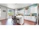 Bright kitchen boasts white cabinets, granite countertops, pendant lighting, and a breakfast bar at 20855 Omaha Ave, Parker, CO 80138