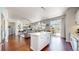 Open-concept layout showcasing the kitchen island flowing into the living area and outdoor deck access at 20855 Omaha Ave, Parker, CO 80138