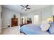 Comfortable main bedroom featuring light gray walls, ceiling fan, and an attached bathroom at 20855 Omaha Ave, Parker, CO 80138