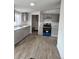 Kitchen features gray cabinets, stainless steel appliances, gray floors and trim, and white counter tops at 7486 Harold St, Fort Lupton, CO 80621
