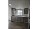 Gray cabinets, white counter tops and a stainless steel sink are featured in this kitchen at 7486 Harold St, Fort Lupton, CO 80621
