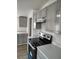 The kitchen features gray cabinets, white counter tops, an electric stove, and stainless steel range hood at 7486 Harold St, Fort Lupton, CO 80621
