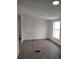 A spacious room with gray flooring, white walls, a double hung window, and a vent at 7486 Harold St, Fort Lupton, CO 80621