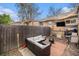 Cozy backyard patio with comfortable seating, fire pit, and Colorado flag for outdoor enjoyment at 3726 Decatur St, Denver, CO 80211