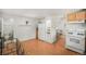Practical kitchen with white appliances, wood cabinets, and open layout connecting to other rooms at 3726 Decatur St, Denver, CO 80211