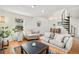 Spacious living room featuring vaulted ceilings and a unique spiral staircase at 3726 Decatur St, Denver, CO 80211