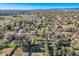 Aerial view of neighborhood including green trees, residential houses, and businesses at 7785 Westview Dr, Lakewood, CO 80214