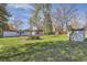 Spacious backyard with lush grass, trees, and shed at 7785 Westview Dr, Lakewood, CO 80214