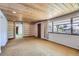 Basement living room with fireplace, shelves and a large picture window overlooking an idyllic yard at 7785 Westview Dr, Lakewood, CO 80214