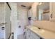 Bathroom features a white tiled wall, shower, toilet and vanity at 7785 Westview Dr, Lakewood, CO 80214