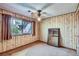 Bedroom featuring paneled walls, fan, and mirror at 7785 Westview Dr, Lakewood, CO 80214