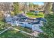 View of home, including the garage, surrounded by green grass and mature trees at 7785 Westview Dr, Lakewood, CO 80214