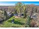 Backyard view including the house, grassy area, a storage shed, and mature trees at 7785 Westview Dr, Lakewood, CO 80214