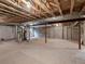 Unfinished basement with concrete walls, exposed ceiling beams, and available utilities, ready for customization at 8579 S Miller Way, Littleton, CO 80127