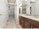 Bathroom vanity features dual sinks, granite counters and dark wood cabinetry at 8579 S Miller Way, Littleton, CO 80127