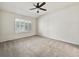 Bright bedroom with a ceiling fan and large window dressed with shutters at 8579 S Miller Way, Littleton, CO 80127