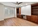 Spacious home office features laminate flooring, built-in cabinets and shelving, and natural lighting at 8579 S Miller Way, Littleton, CO 80127