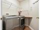 Laundry room area with modern side-by-side washer and dryer at 8579 S Miller Way, Littleton, CO 80127