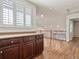 Inviting loft area with laminate flooring, a built-in cabinet, and bright natural light from shuttered windows at 8579 S Miller Way, Littleton, CO 80127