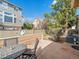 Cozy outdoor patio with stone pavers, a table and chairs, and a well-maintained fenced yard at 8579 S Miller Way, Littleton, CO 80127