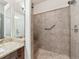 Walk in shower features a tiled surround and a built in bench at 8579 S Miller Way, Littleton, CO 80127