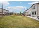 Spacious backyard with lush green lawn and patio, enclosed by a wooden fence at 12797 Clearview St, Firestone, CO 80504