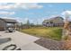 Backyard view showcasing a lush lawn, patio area, and privacy fencing at 12797 Clearview St, Firestone, CO 80504