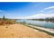 Sandy beach leading to a serene community lake, perfect for relaxation and enjoying waterfront views at 12797 Clearview St, Firestone, CO 80504