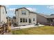 Back exterior featuring a well-maintained lawn, patio space, and modern siding at 12797 Clearview St, Firestone, CO 80504