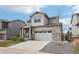 Two-story home with stone accents, gray siding, a two-car garage and a concrete driveway at 12797 Clearview St, Firestone, CO 80504