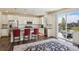 Bright kitchen with white cabinets, stainless steel appliances, granite countertops and island seating at 12797 Clearview St, Firestone, CO 80504