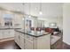 Open-concept kitchen features an island with bar seating that overlooks the living area at 12797 Clearview St, Firestone, CO 80504