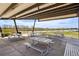 Covered picnic area with tables offers a scenic view of the lake and surrounding community amenities at 12797 Clearview St, Firestone, CO 80504