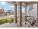 Inviting porch with stone columns and two chairs, perfect for relaxing and enjoying the neighborhood view at 12797 Clearview St, Firestone, CO 80504
