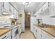 Efficient white kitchen with butcher block countertops and a clean, bright design at 1001 W 112Th Ave # D, Westminster, CO 80234