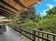 Relaxing back deck offers views of lush greenery, mature trees, and a serene outdoor environment at 1075 Dudley St, Lakewood, CO 80215