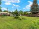 An expansive backyard with mature trees, a lush lawn, and a charming garden at 1075 Dudley St, Lakewood, CO 80215
