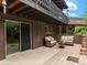 Backyard patio featuring outdoor seating and access to upper deck at 1075 Dudley St, Lakewood, CO 80215