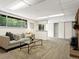Well-lit basement living space with cozy seating, fireplace, bar area and access to the outdoors at 1075 Dudley St, Lakewood, CO 80215
