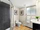 Bathroom featuring black tiled shower, toilet, and sink with granite vanity at 1075 Dudley St, Lakewood, CO 80215