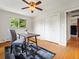 Neutral bedroom features include a ceiling fan, closet, and a window with a view, all complementing the hardwood floors at 1075 Dudley St, Lakewood, CO 80215