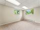 Bedroom featuring neutral carpet and natural light from two windows at 1075 Dudley St, Lakewood, CO 80215