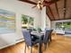 Stylish dining room with hardwood floors, a modern table with seating for six, and vaulted ceilings at 1075 Dudley St, Lakewood, CO 80215