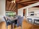 Inviting dining room featuring wood floors, vaulted ceilings, and seamless access to the kitchen at 1075 Dudley St, Lakewood, CO 80215