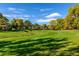 A lush green space with a bridge in the distance, perfect for recreational activities and outdoor enjoyment at 1075 Dudley St, Lakewood, CO 80215