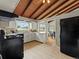 Bright kitchen with white cabinetry, wood-beam ceilings, and modern appliances at 1075 Dudley St, Lakewood, CO 80215
