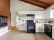 Practical kitchen with stainless steel appliances, brick accent wall, and ample cabinet storage at 1075 Dudley St, Lakewood, CO 80215